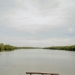 a wooden bench sitting on top of a lush green field